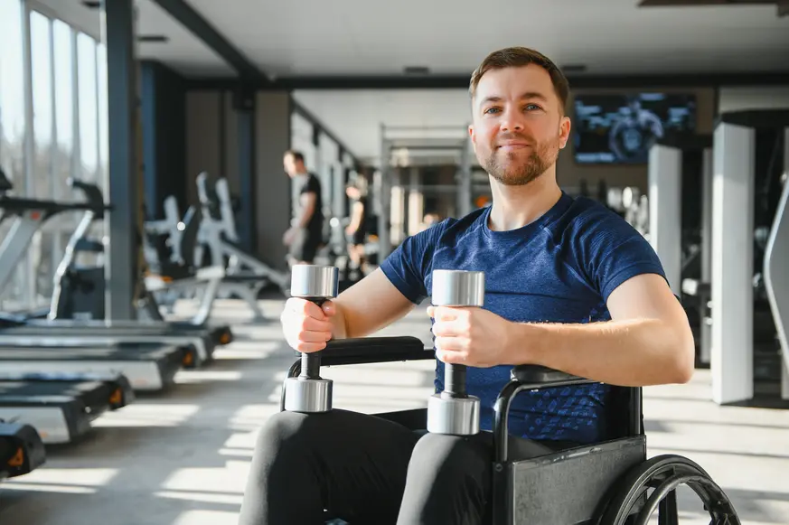 Disabled man in wheelchair at gym