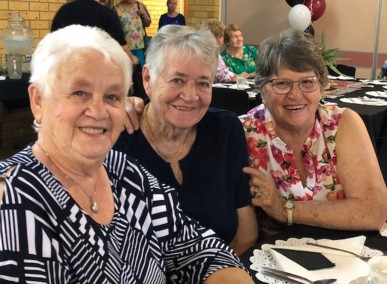 Three elderly women smiling at camera