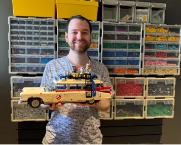 Happy man holding car up to camera